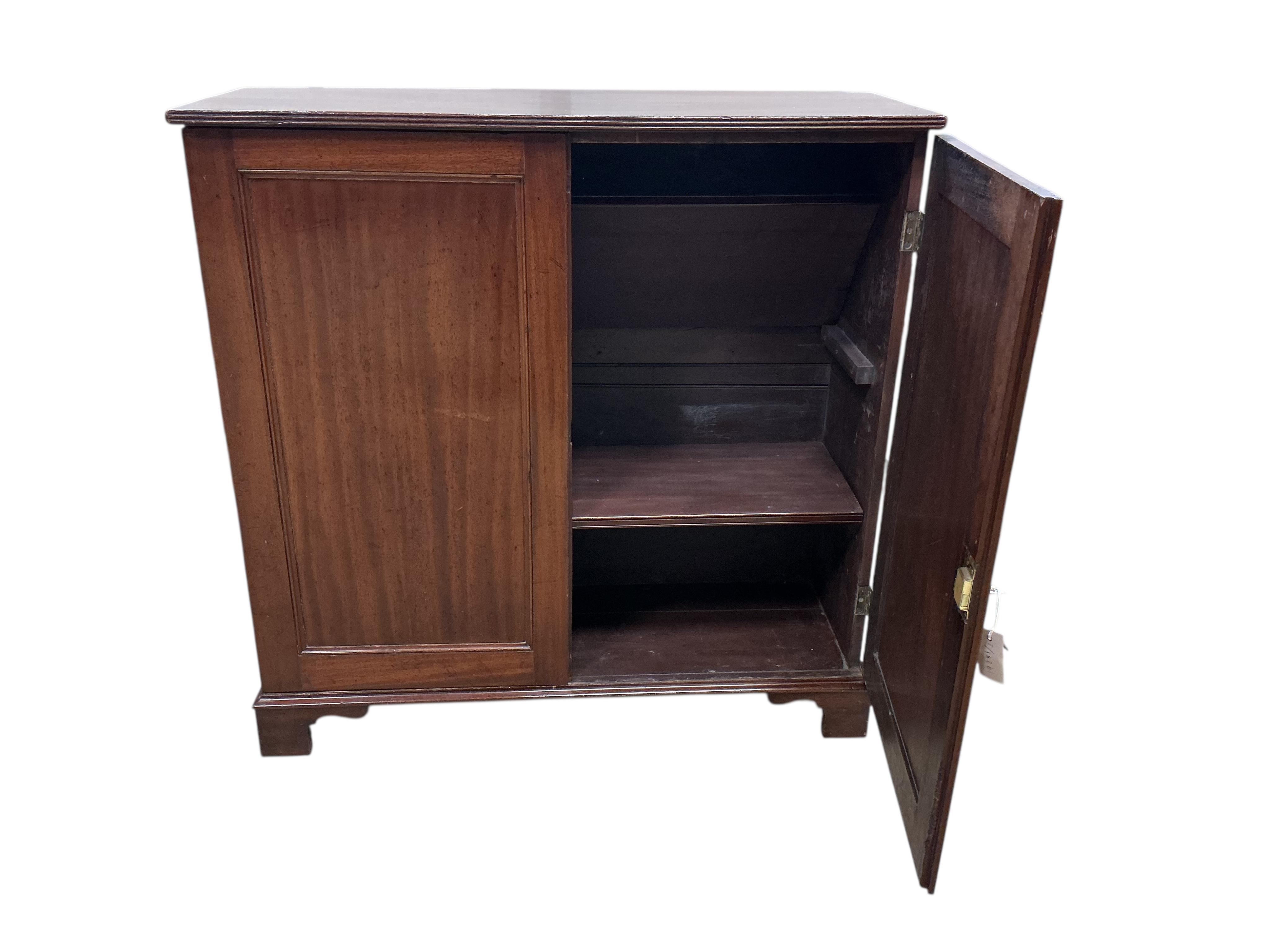 An early 19th century mahogany two door side cabinet, width 103cm, depth 37cm, height 104cm